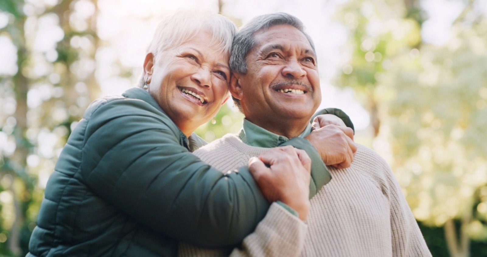 Older couple smiling together outdoors